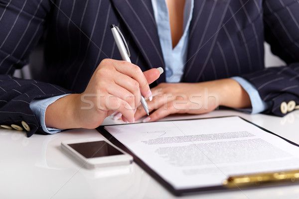 4191305_stock-photo-young-woman-reads-a-signed-contract